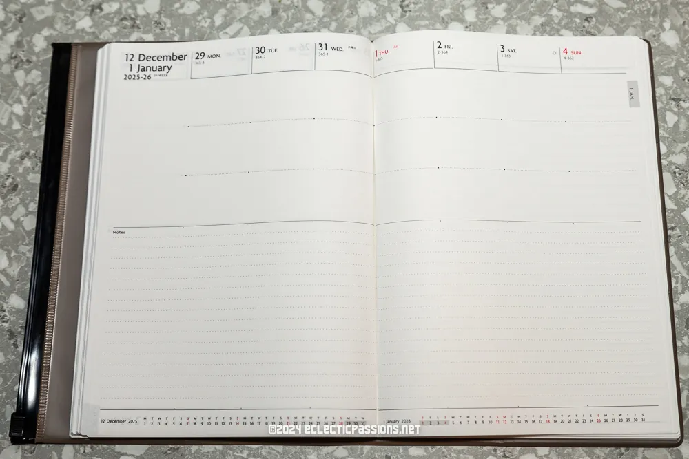 An open planner displaying a weekly calendar layout for the end of December 2024 and the beginning of January 2025. The dates shown are from December 29 to January 5, with spaces for notes at the bottom. The background is a speckled gray surface.