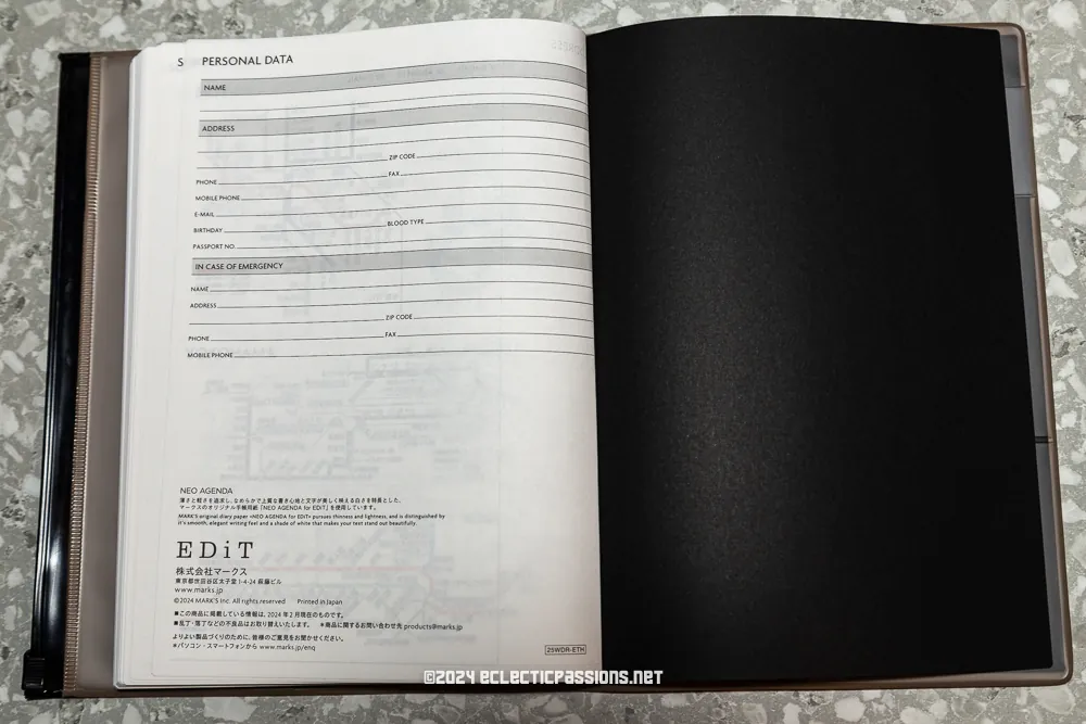 An open planner lies on a textured surface. On the left page, there's a form titled "PERSONAL DATA" with fields for contact information. The right page is black and blank. The bottom reads ©2024 ecletricpassions.net.