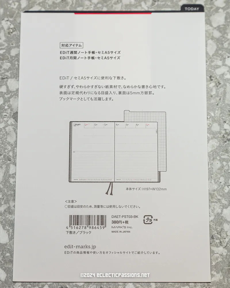 A book with a cover showing a diagram of an open planner or notebook. The text is mostly in Japanese, detailing product features and dimensions. The background is a speckled gray surface, and a copyright notice is at the bottom.