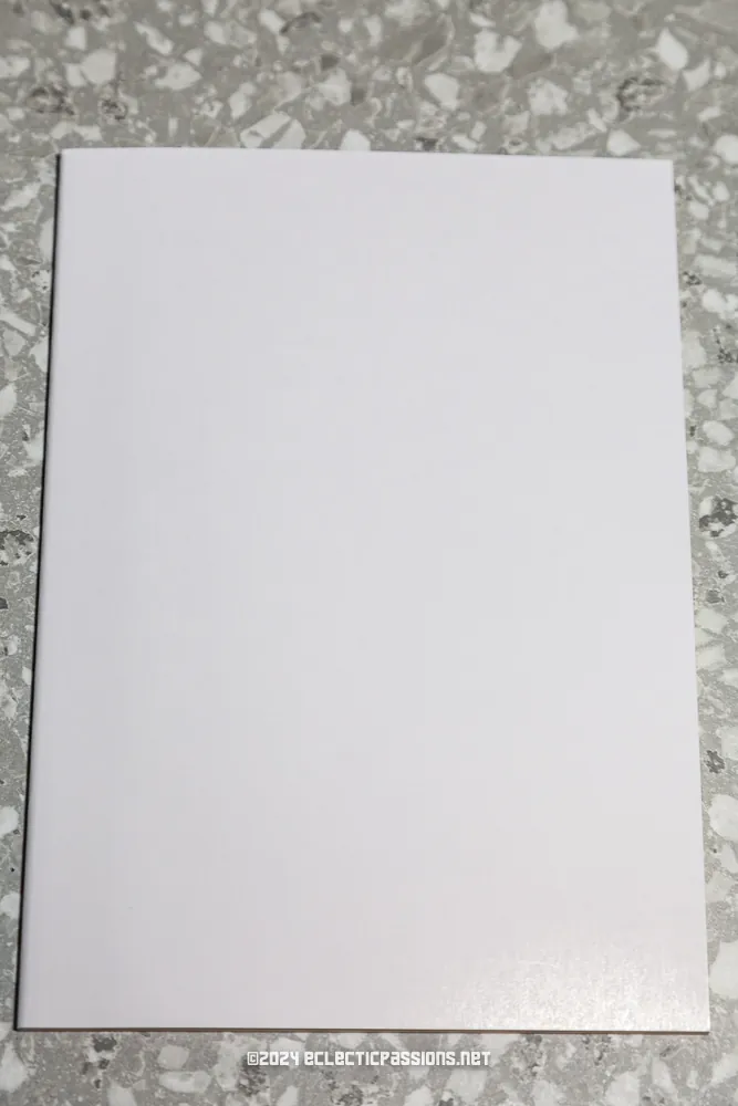 A blank white piece of paper is placed on a gray, speckled countertop. The paper has no visible markings or text.