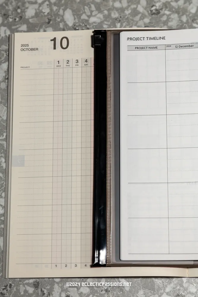An open planner displays a calendar for October 2025 on the left with vertical lines for daily tasks. On the right, a project timeline section features columns for project names and dates. A pen is placed between the pages.